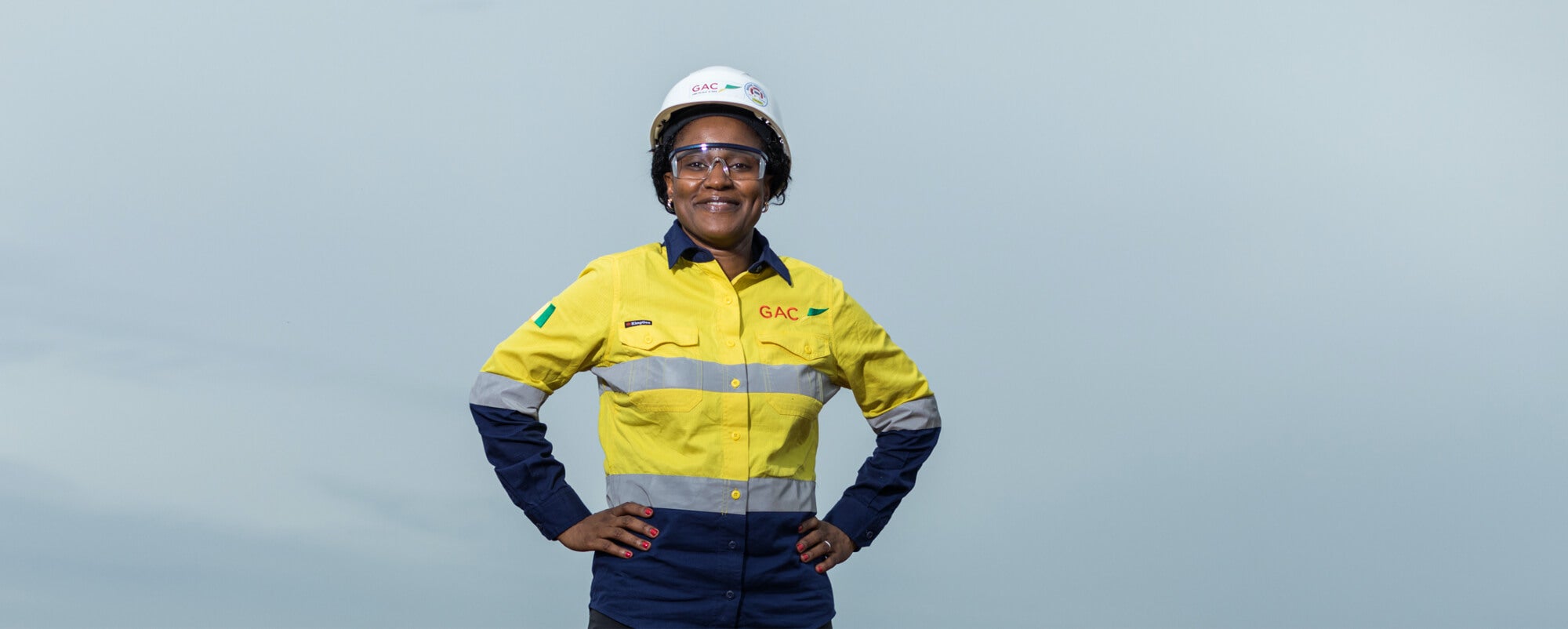Profile Aissata Beavogui with a hardhat and her company uniform